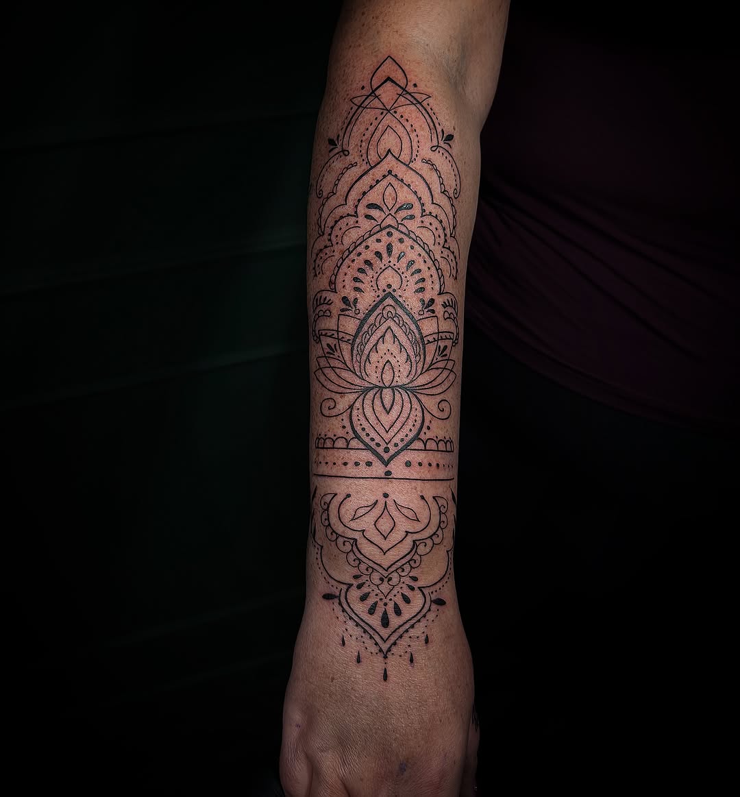 Ornamental mandala forearm tattoo